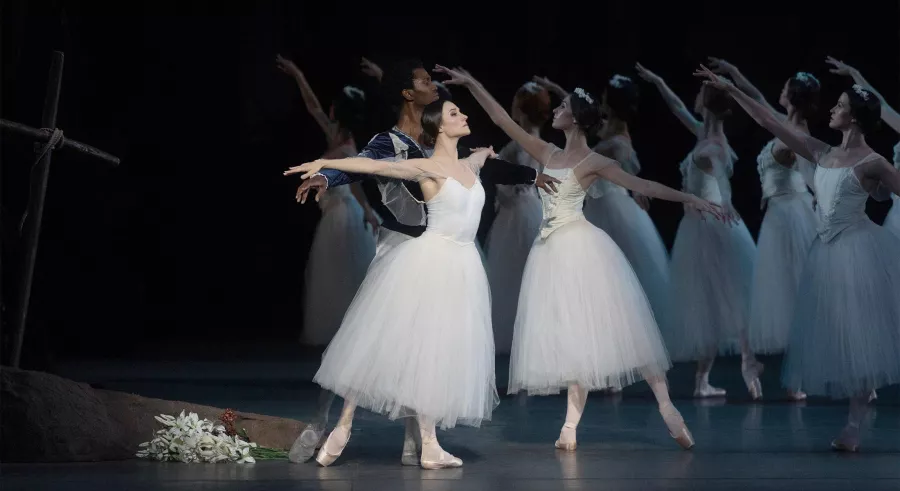Ballet dancers pass one another in formation.