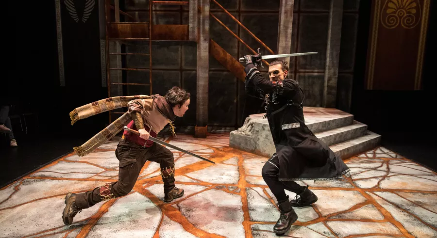 Stage combat in a play setting with swords