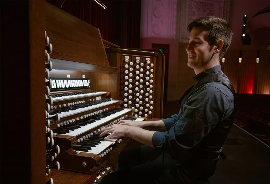 Greg smiles while playing the Northrop organ