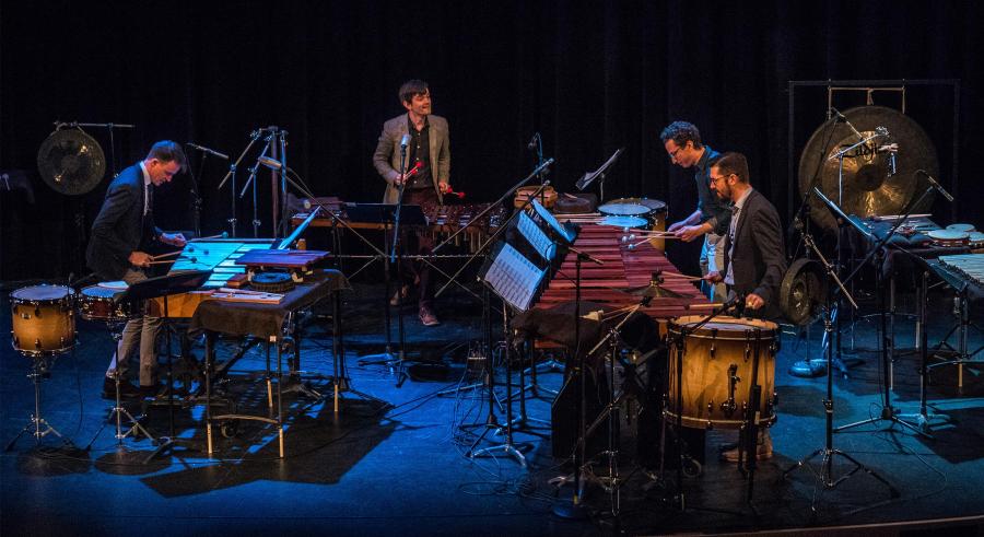 Percussionists play different instruments on stage.
