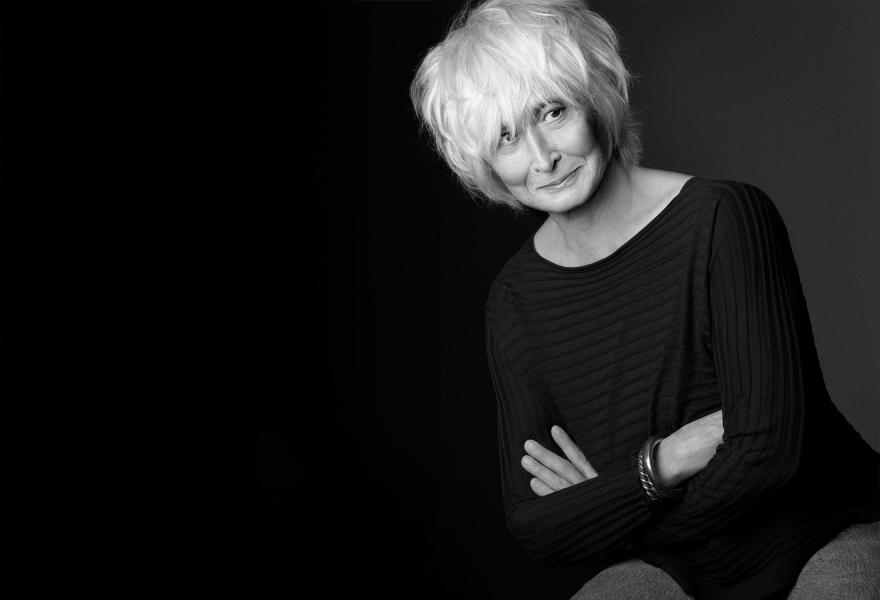 Twyla Tharp with her arms crossed in a black and white portrait