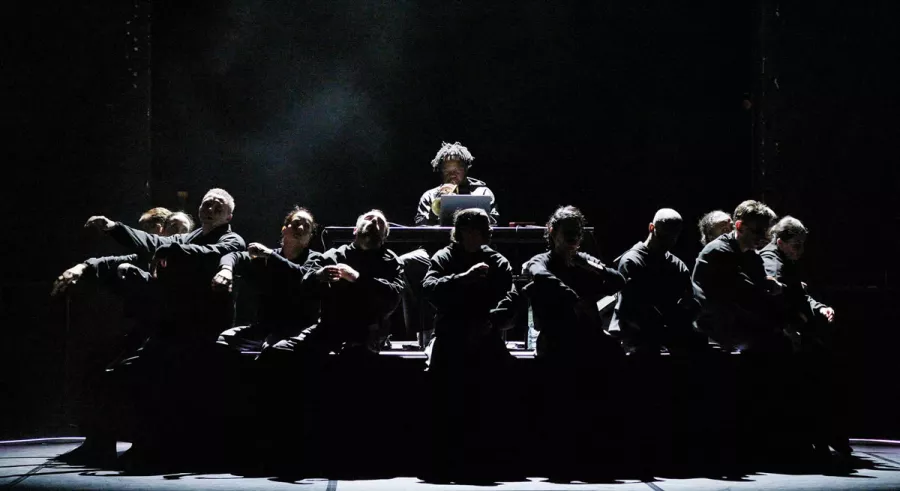 Close up image of A a | a B - BEND dance company seated infront of the DJ. 