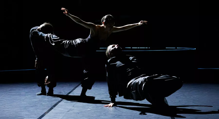 Three company members create elongagted shape in a straight line. 