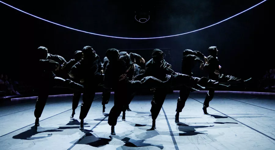 A a | a B - BEND dance company kicks their legs to the right in sync.