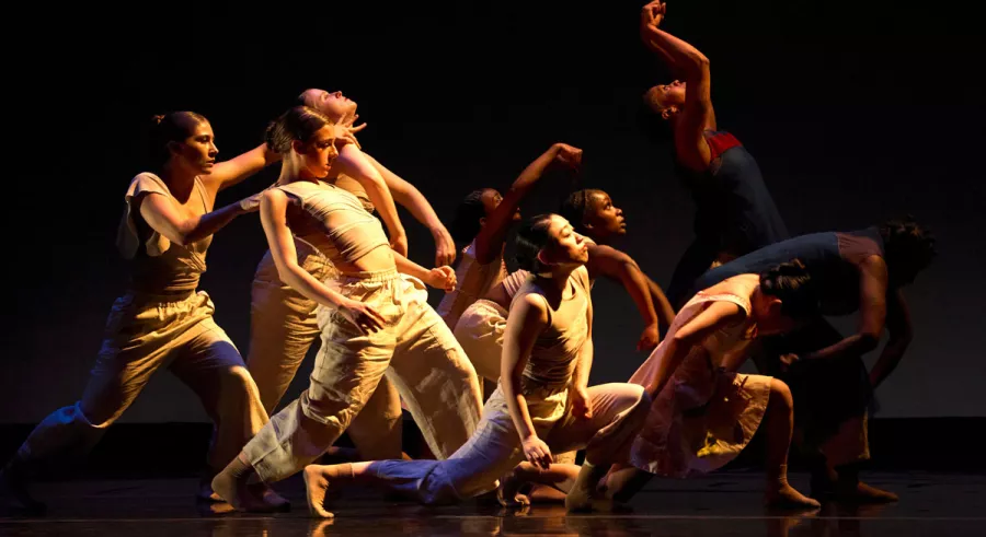 A dynamic scene, with eight dancers captured in various expressive poses.