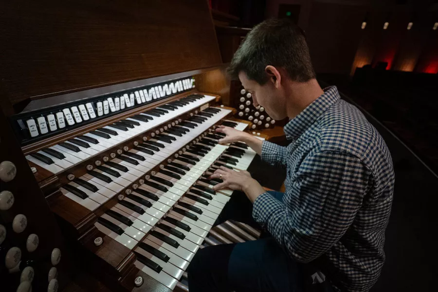 Side view of Greg at the Northrop organ keyboards.