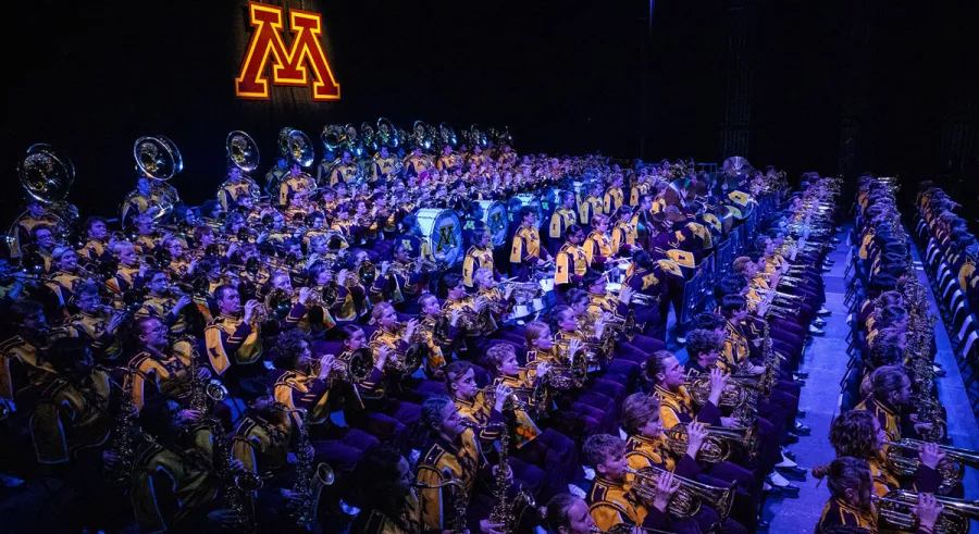 A side view of the entire UMN Marching Band performing onstage at Northrop.