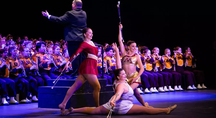 The three UMN Feature Twirlers pose after a performance in front of the entire band onstage. 