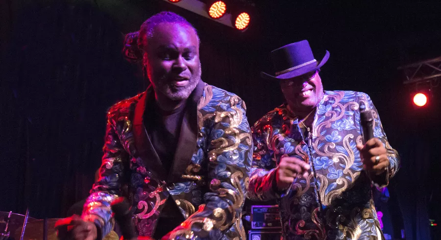 The leaders of the bank in their color jackets smile while playing