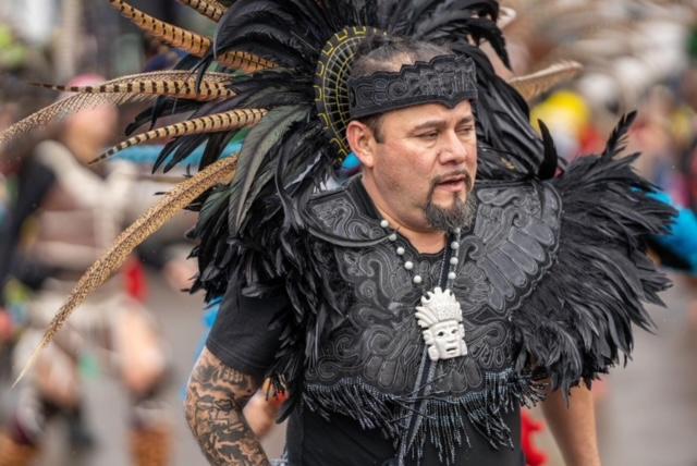 Male performer in black feathers