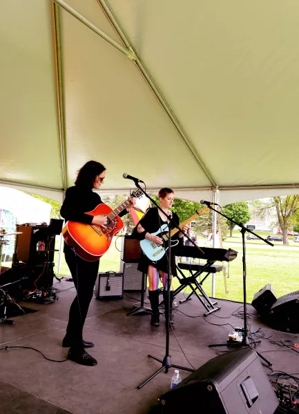 Both artists playing guitars on the stage in Rochester
