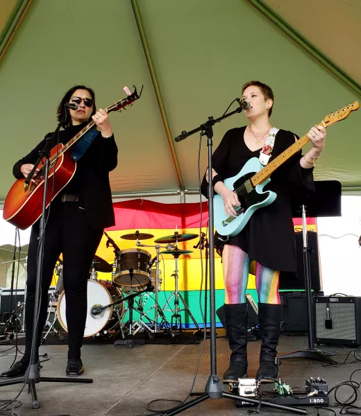 Kelsey sings as they both play guitars