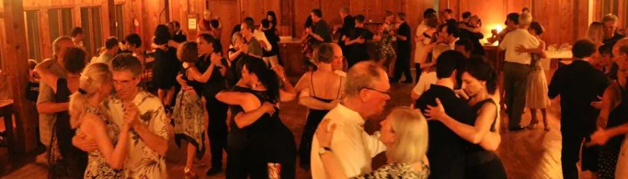 Couples dancing under a reddish light