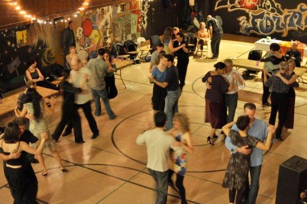 Couples tango in the a festive gymnasium