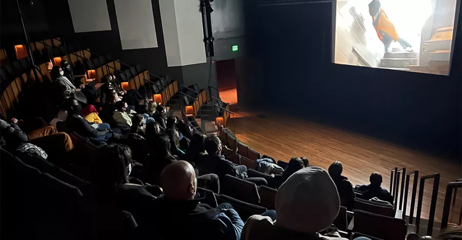 Audience members watch from a screen in the Best Buy Theater.