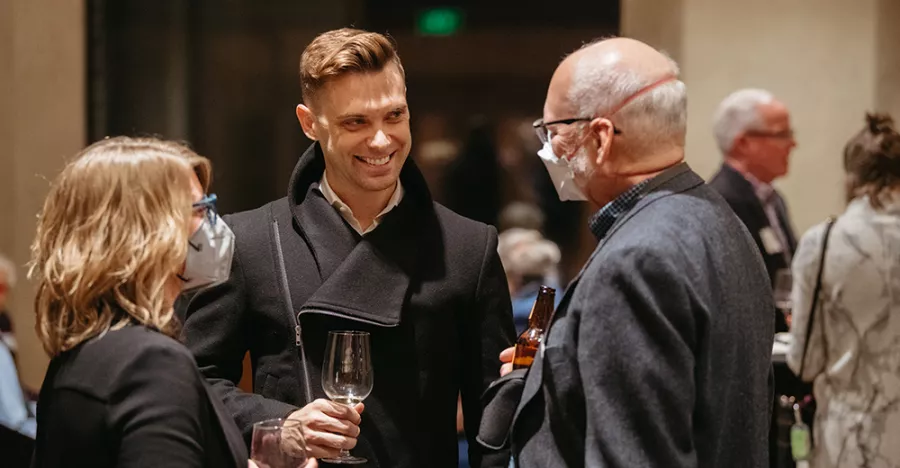 People engaging in conversation with Paul Taylor Dance Company Artistic Director, Michael Novak. Novak is wearing a black jacket.