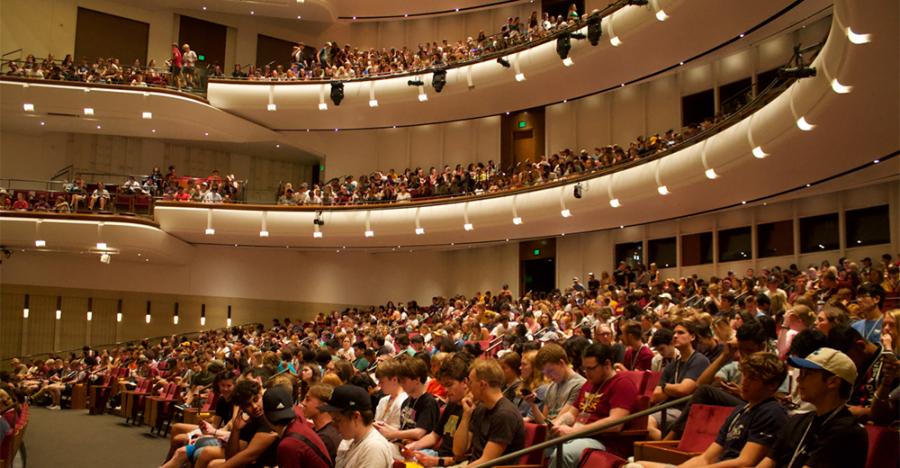 University of Minnesota undergraduate students fill the Northrop's theater. All three levels of seats are filled with eager students. 