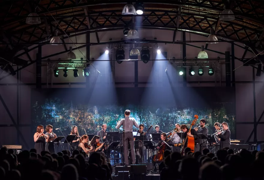 Alarm Will Sound orchestra performing on a stage