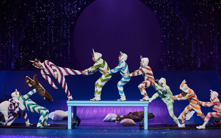 cast wearing striped costumes in a tableau on a table
