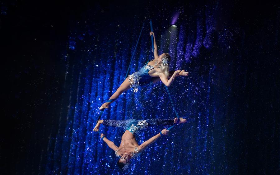 2 performers suspended in the air by straps