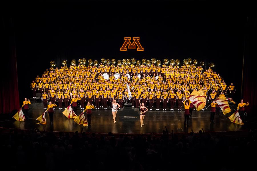 On the Carlson Family Stage the University of Minnesota Marching Band poses in-full for a group portrait.