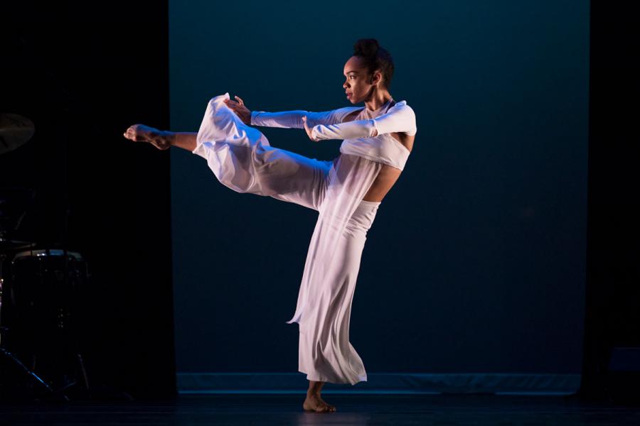 A female dancer wearing white performs on stage.