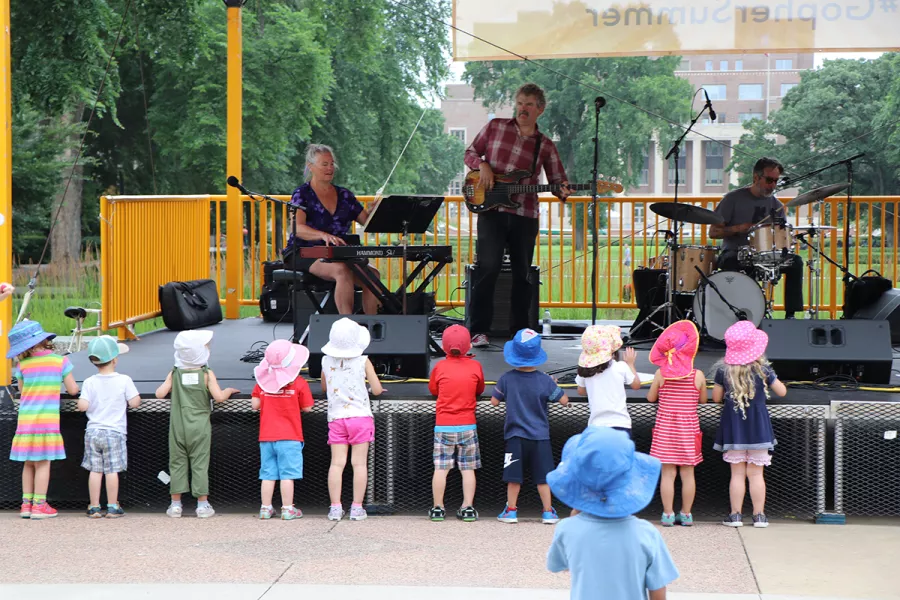 Small kids in hats at the front of the stage watching The Fragrants perform.