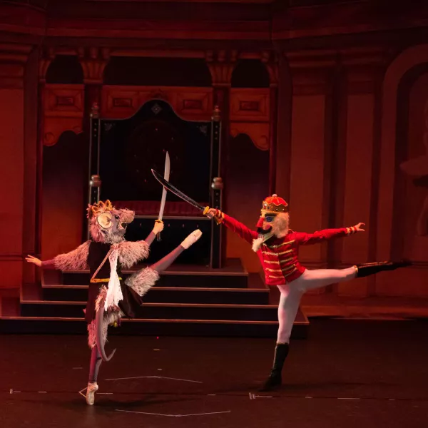 A dance 'battle' between two dancers. One dressed as the 'Rat Queen' and the other as the 'Nutcracker'
