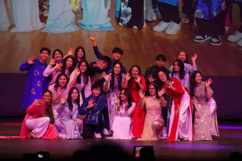 VSMA Coordinators pose in a group waving to the audience
