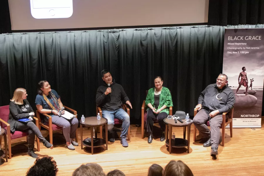 Five people, four members of Black Grace along with Kristen Brogdon, Northrop's director of programming all sit have a discussion on the stage in Northrop's Best Buy Theatre.