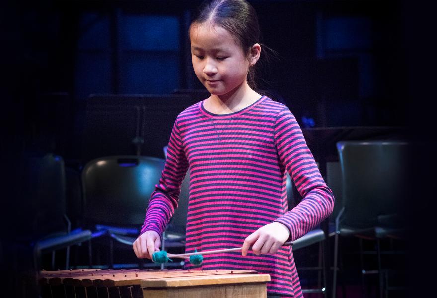 Young girl plays xylophone 